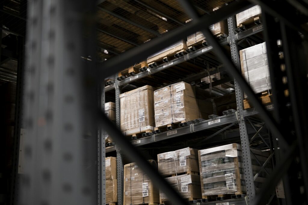 Wrapped goods on warehouse pallet racks — illustrative industry photograph